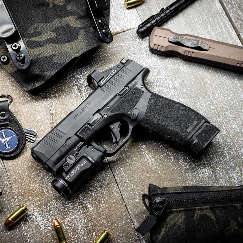 The Hellcat Pistol on a table with a 17-round magazine.