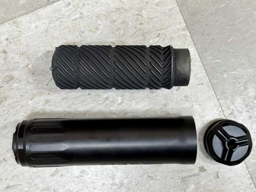 A disassembled suppressor lays on the floor.