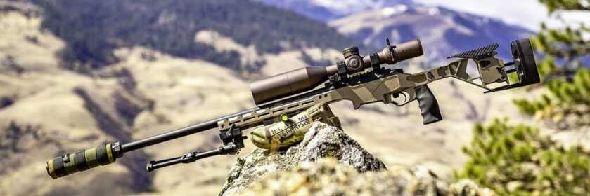 Seekins Havak HIT sits on a rock in mountainous terrain.