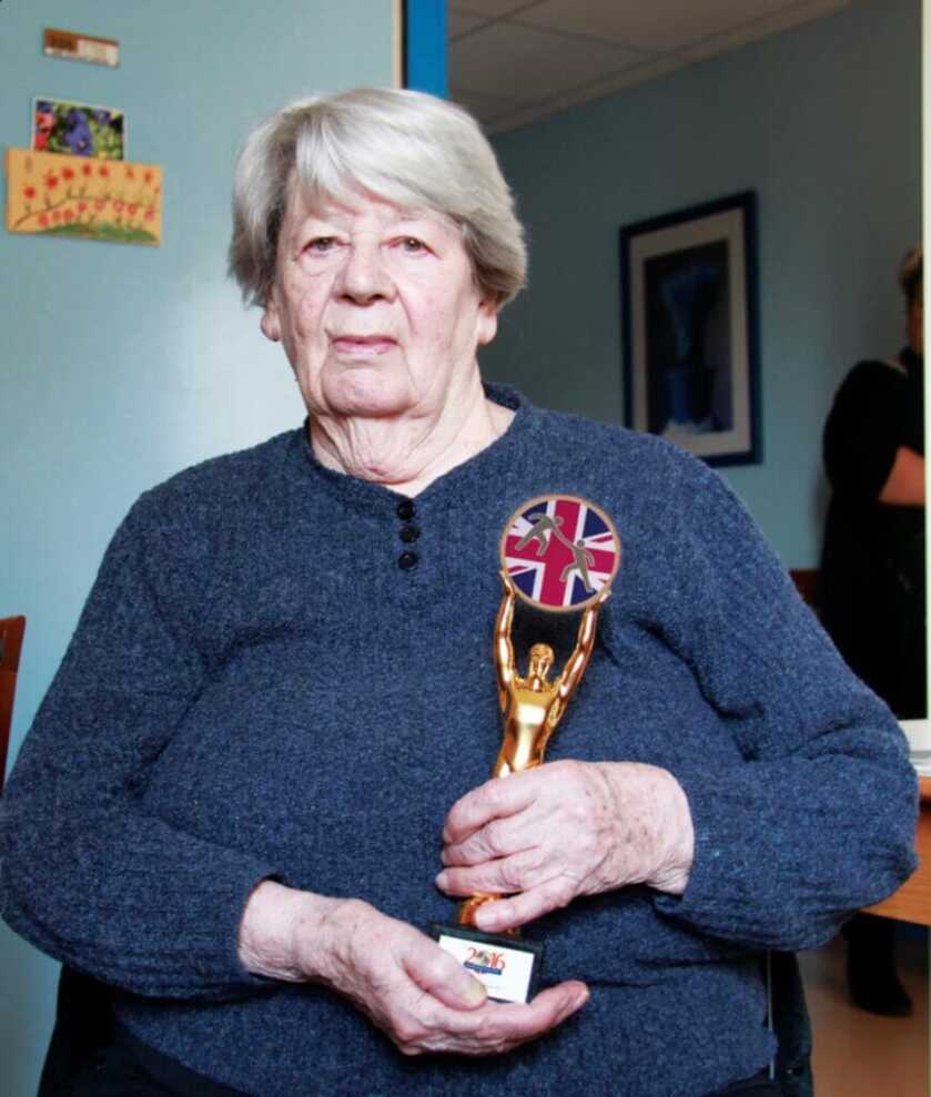 Simone Segouin grown up holding an award
