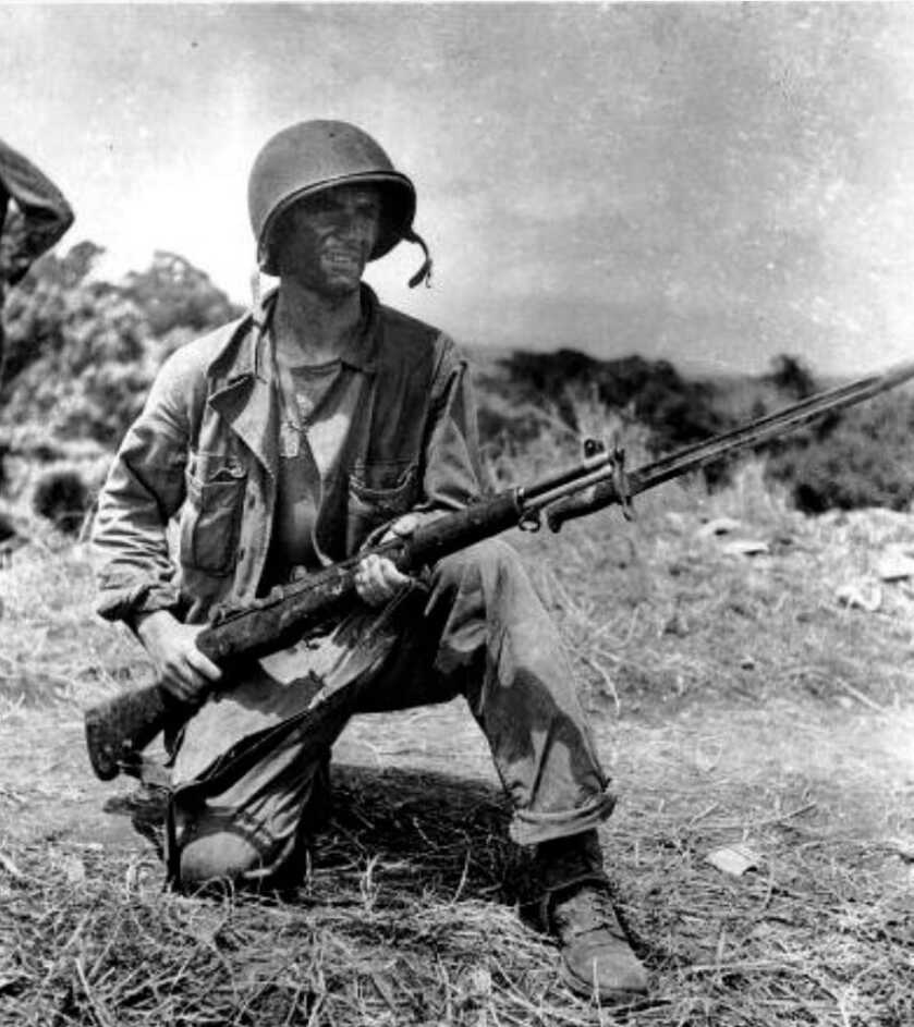 black and white photo of a young soldier holding a bayoneted rifle