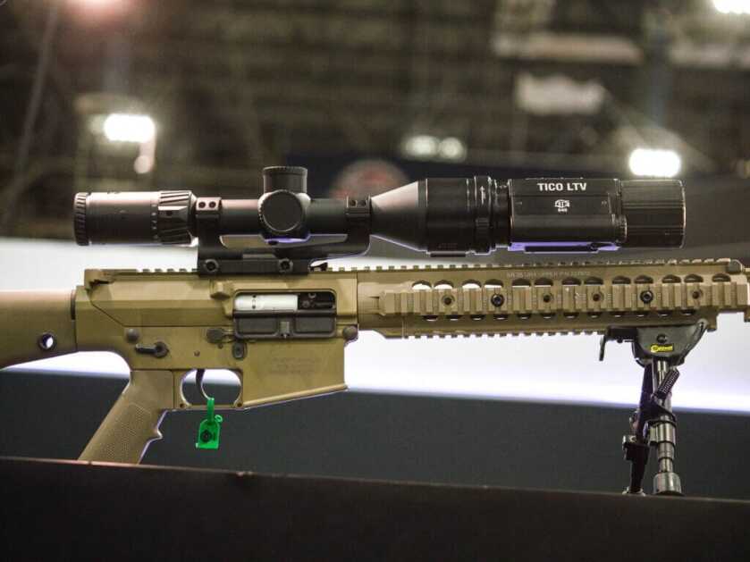 View of the right side of a n AR with a daylight scope and the TICO mounted to the front.