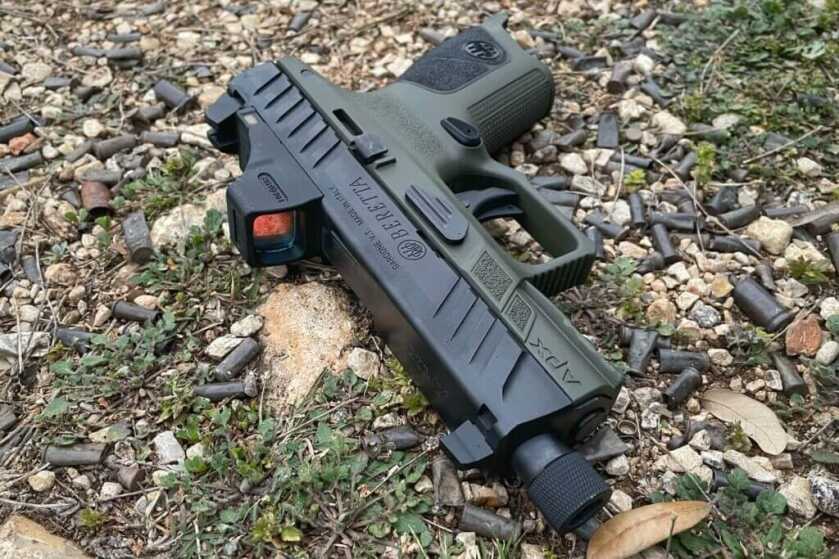 Beretta APX A1 Compact Tactical with Holosun SCS on ground with brass