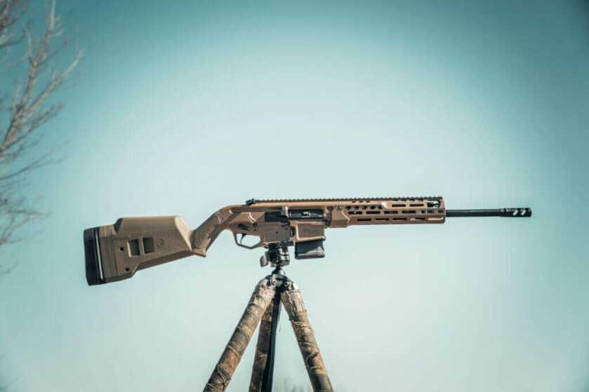 The SIG MCX Regulator on an RRS tripod. It has a built-in ARCA rail between the trigger guard and magwell.