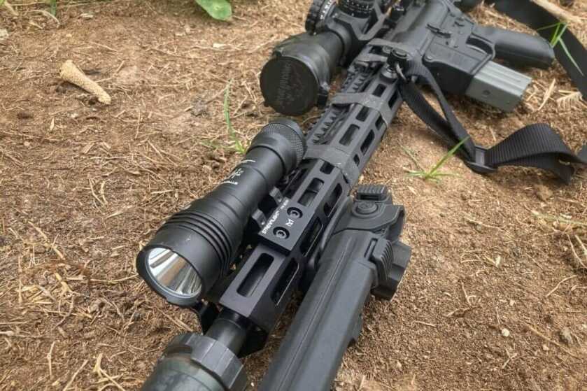 Streamlight’s HLX Pro mounted on rifle resting outside on forest floor

