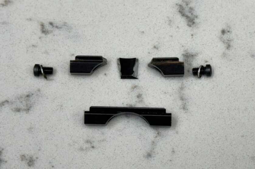 parts for gun sitting on marble counter
