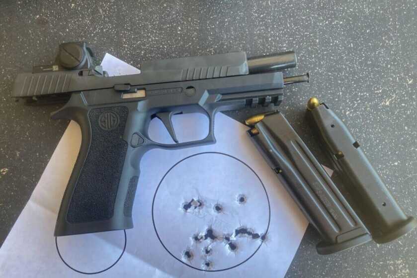 Sig Sauer BXR3 with magazines and target with holes in it