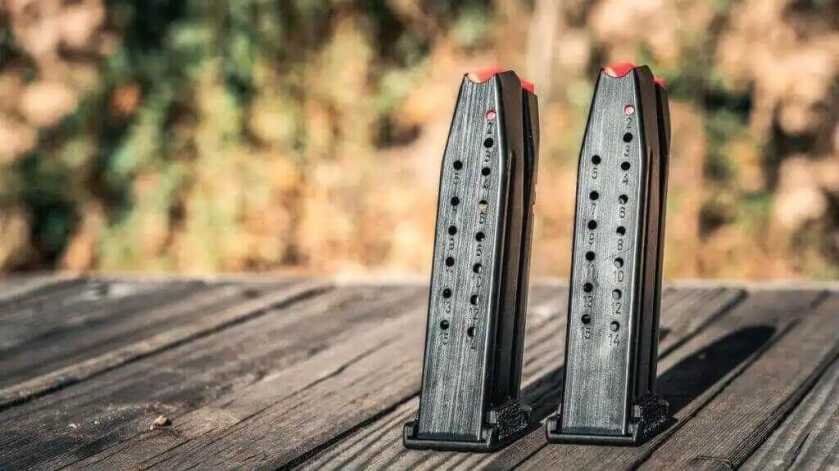 Two magazines with red tops on wooden table