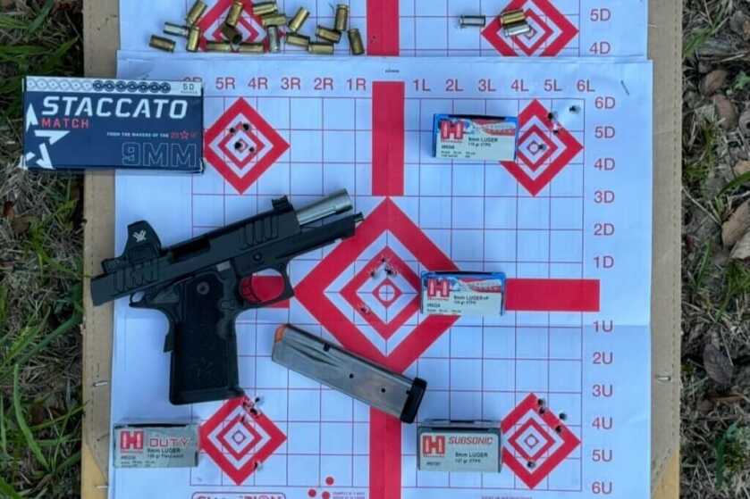 Staccato C with magazines and boxes of ammo on paper target