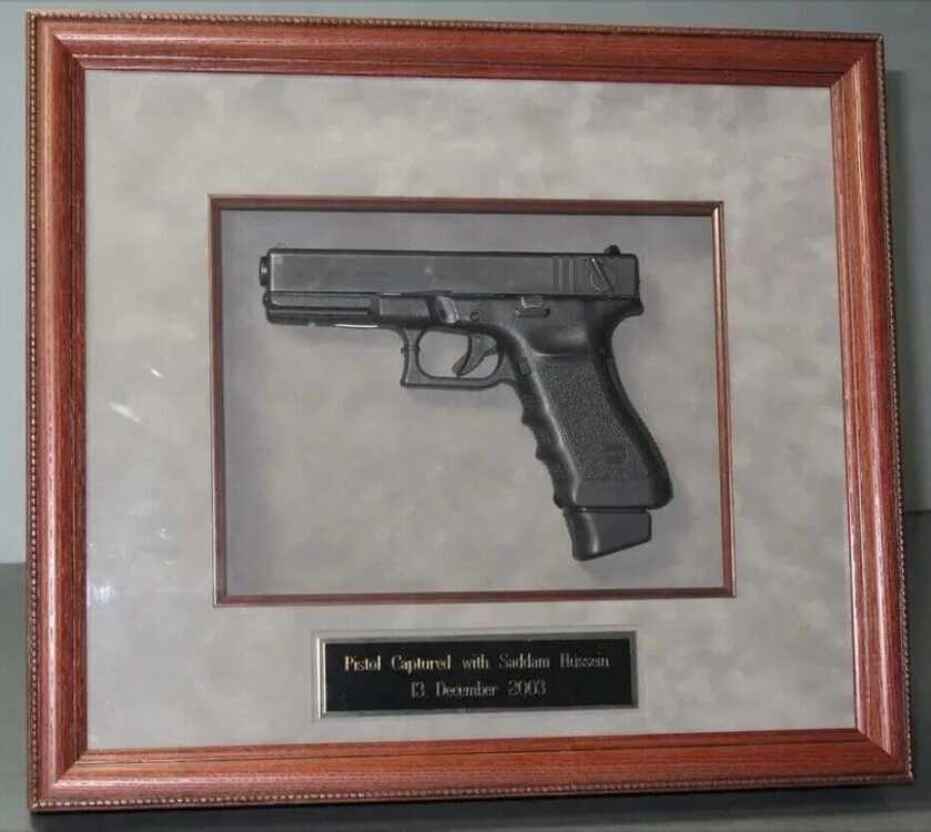 pistol in a frame. hussein