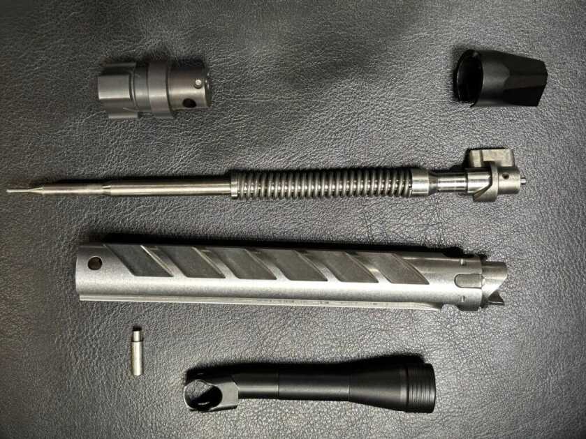 Closeup of a disassembled rifle bolt.
