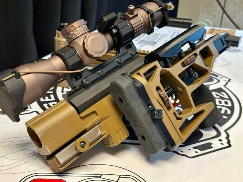 closeup view of the action and chassis of this takedown rifle. The stock is folded to the side.