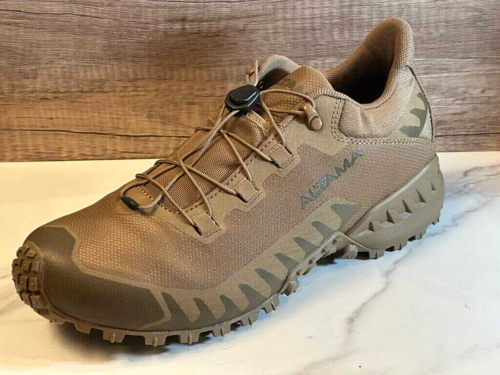 A tan tennis shoe is on display on a white marble floor.