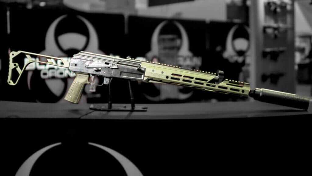 Whole gun sitting upright on a table facing right.