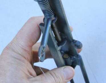 Prepping 101: Perimeter Alarms - Low Tech Security for The mine works by releasing a spring captured nail. It hits a .22 caliber nailgun blank, creating a report. That ring on the end is tied to the trip wire, and you can see the blank holder at the bottom. This will not hold a live .22 caliber round with a projectile. There is a small space at the bottom to exhaust the gas from the blank.