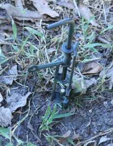 Prepping 101: Perimeter Alarms - Low Tech Security for The tines on the bottom of the alarm are set perpendicular to the trigger, so even in soft soil they work great.