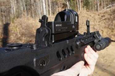 The iron sights pop up out of the frame.