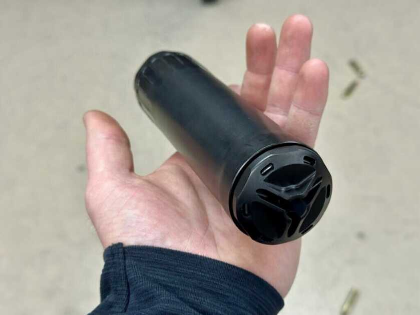 Suppressor sits in the hand of an experience shooter
