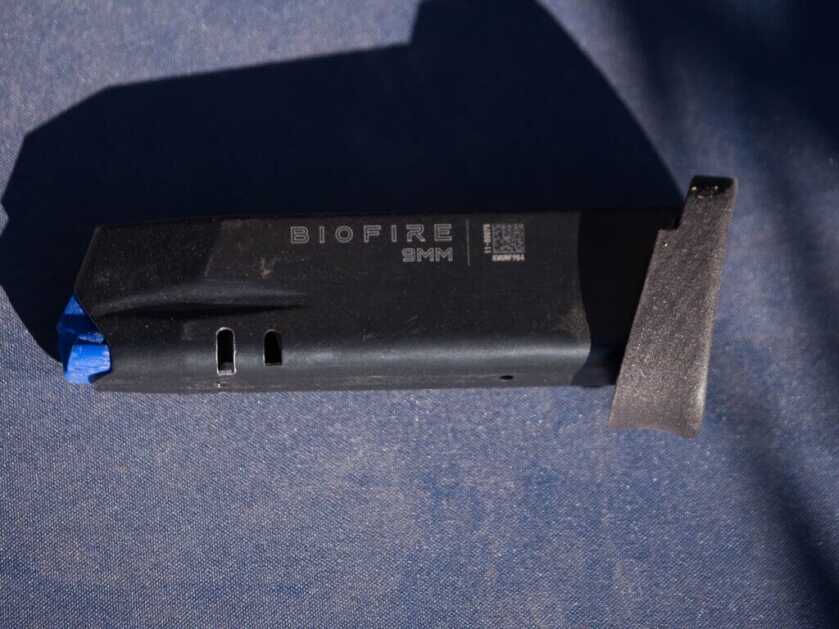 The magazine, empty, lying on the table.