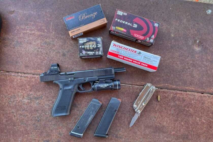 Glock 17L with magazines and boxes of ammo