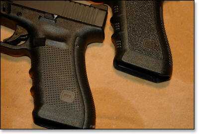 The new grip texture of the Gen 4 (bottom) compared to the Gen 3 (top). You can also see the larger mag release on the Gen 4.