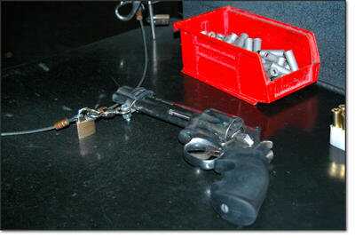 Guns are tethered safely in the stalls of the shooting range to prevent any accidents