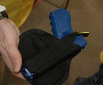 An earlier design, the Rocket model, holds the gun securely in place via an elastic strap.