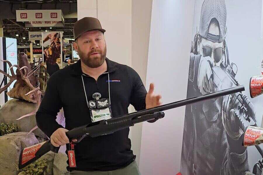 True holding a Benelli Nova 3 at SHOT Show 2025.