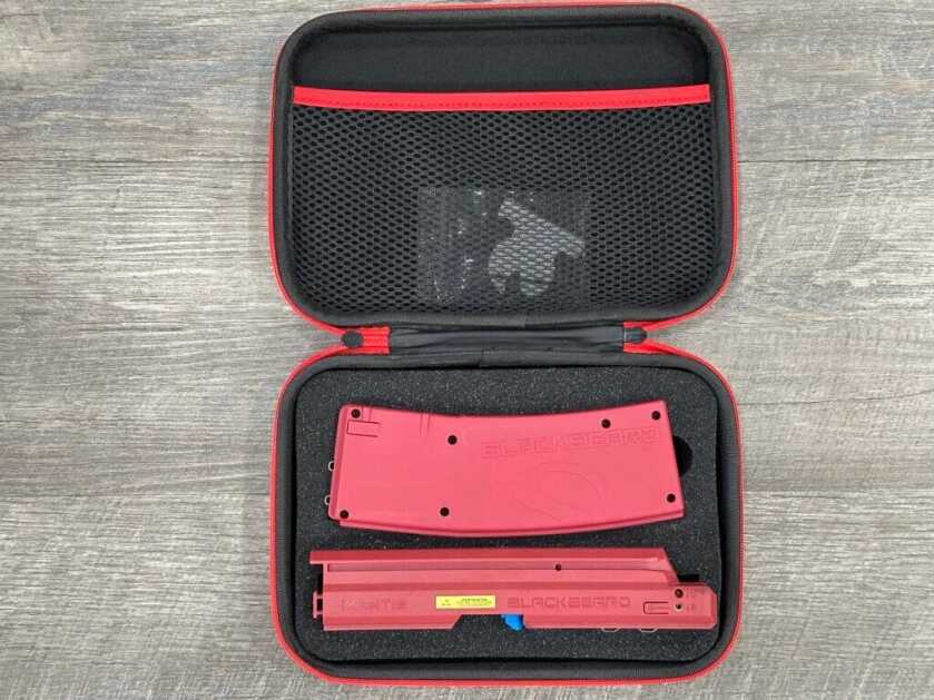 The red BlackbeardX training device sits in its storage case.