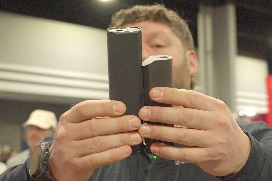 True holding up new SilencerCo suppressors.