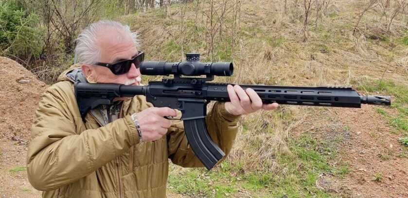 man holding the ar-15 complete 7.62x39 ourtdoors