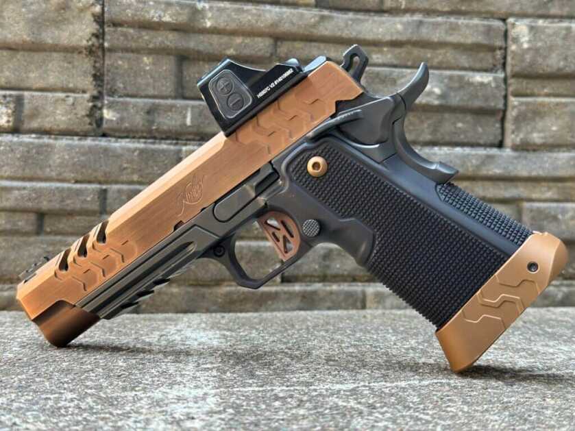 Side profile of a bronze and black two-tone 2011 on a concrete and stone background. 2K11 Target (OR)