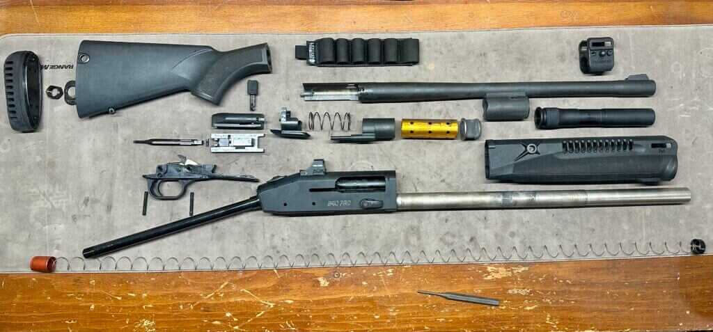 940 Pro Tactical SPX completely disassembled and laid out on the table to showcase the parts.