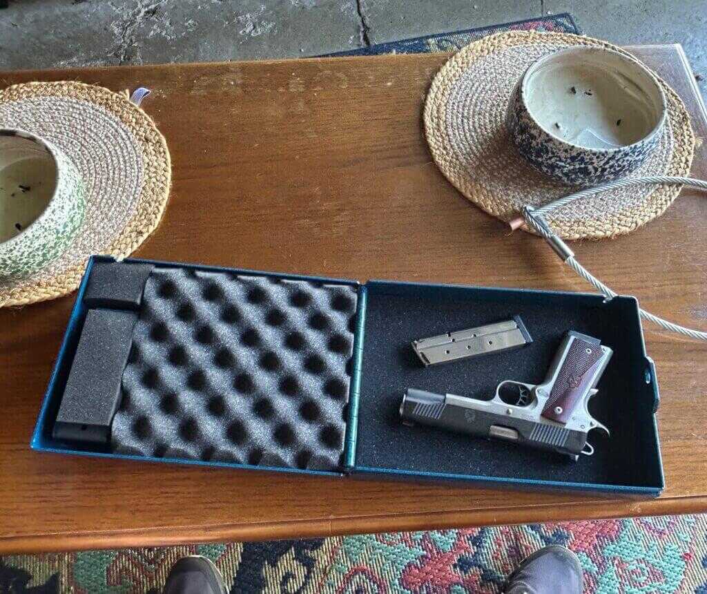 Steelhead lock box open on a table with Springfield Ronin 1911 and magazine inside.