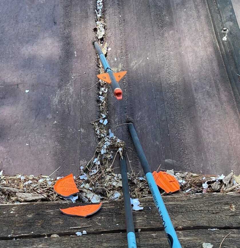 Ravin R470 clay pigeon hit at 100 yards showing arrow impact on wood backer