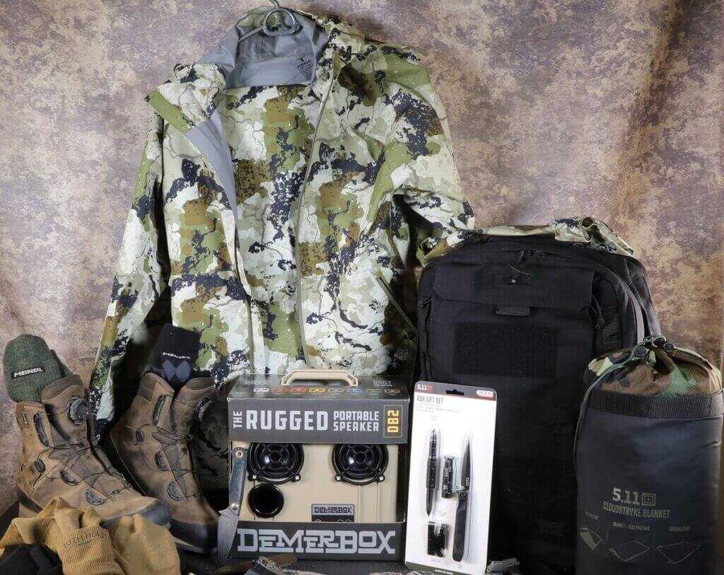 2025 tactical gift guide gear pile with knives, boots, rain gear, and EDC essentials