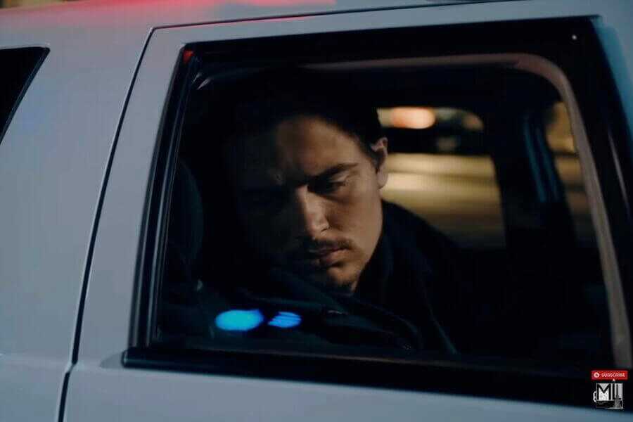 A man pulled over in a car, not happy about the situation.