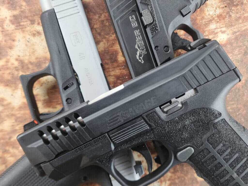 used polymer handguns lined up for sale on a counter buying used guns tips