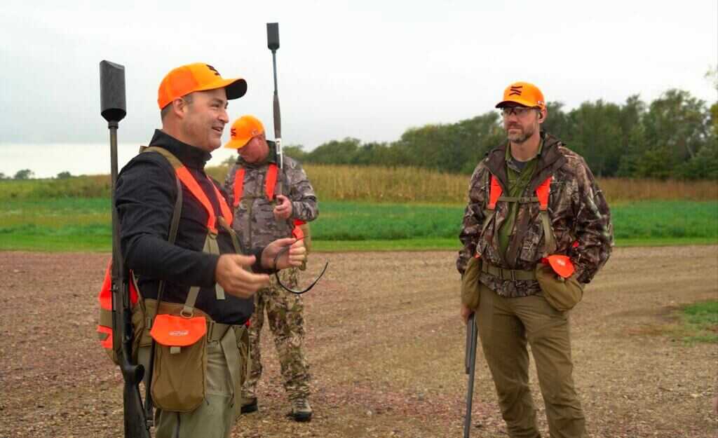 Group in camo and orange at the 20th Anniversary Pheasant Hunt