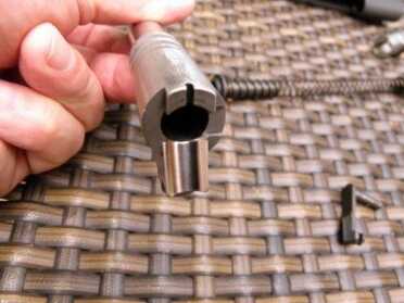 Feed ramp and barrel are combined, a feature which contributes to reliable feeding. The notch at the top of the barrel provides a visual check for a chambered round.