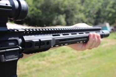 I shoot thumb-over-bore because it lets me pull the gun into my shoulder. The hold is the best I've found for minimizing barrel movement.