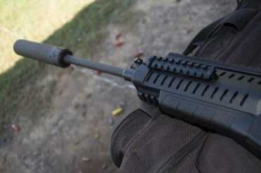 I mounted a SilencerCo Saker 556 just for kicks. It worked fine, but the combo resulted in a hot gas facial.