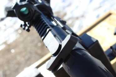 Charging handle like an AR. This would be a good set up to use a side charging upper with. 