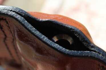 The holster is open on the end, but the muzzle is still protected.