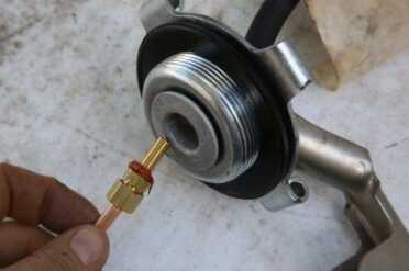 Prepping 101: Urban Survival Heater Stove Burns Oil/Gasoline 45k BTU Inside the cap there is a threaded hole for that silver tube. I used gasket material and this hose barb and glued my system in.