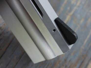 The front sight is wide, and flat black. But it is pinned, so it can be swapped out for something else easily enough.