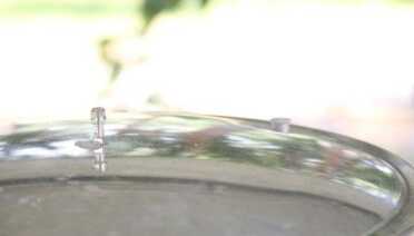 After you seal the lid, bring the canner to a boil and let it steam for at least ten minutes to expel all of the air. I usually put the weight on for a minute to get that pressure indicator to pop you see there in the back, then I take the weight back off to let the steam escape for another ten minutes or so. 