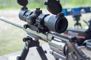 The iron sight is not in the way of the included red dot, but I had to remove it to mount a magnified scope.