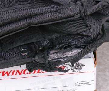 Shooting From Off-Body Carry: The Man-Purse Test Shooting from a bag leaves a hole in the bag. We had hypothesized that this would occur. But what happens if there's stuff in the bag--like an extra mag or two?