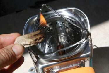 The Biolite comes with some oil soaked tinder. It smells bad but works good. Leave the fan off until your biomass is going or it will put it out. 